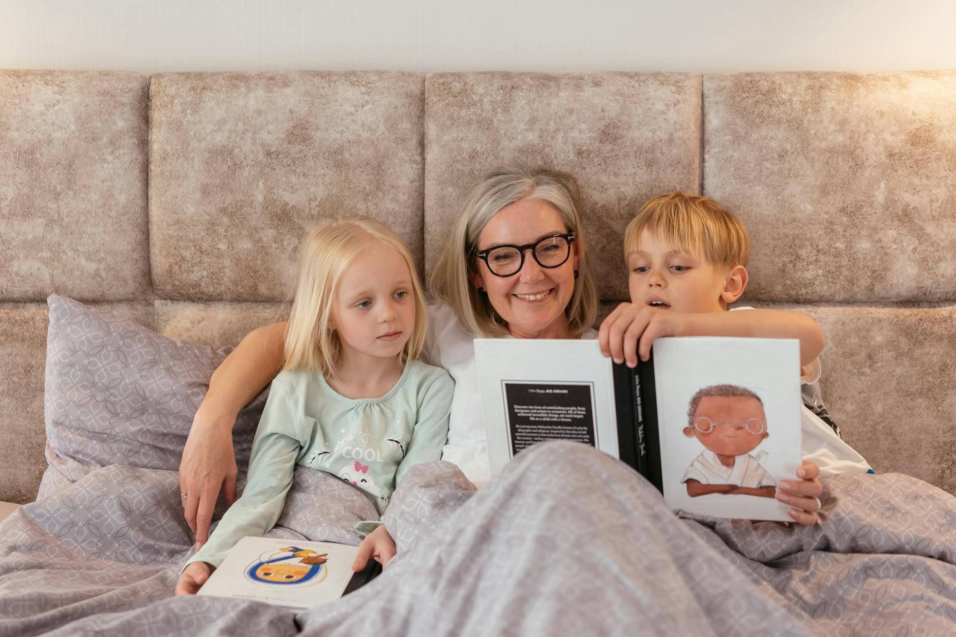 grandmother reading a book for the kids